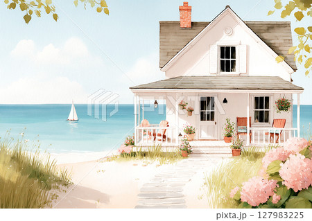 Charming coastal cottage with white exterior and porch, surrounded by blooming flowers and sandy beach, offering a serene seaside atmosphere 127983225