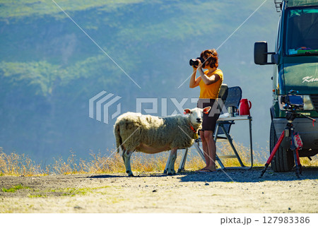 Tourist taking photo in norwegian nature Tourist taking photo in norwegian nature 127983386