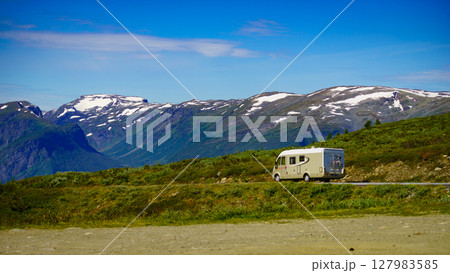 Camper car on road in norwegian mountains Camper car on road in norwegian mountains 127983585