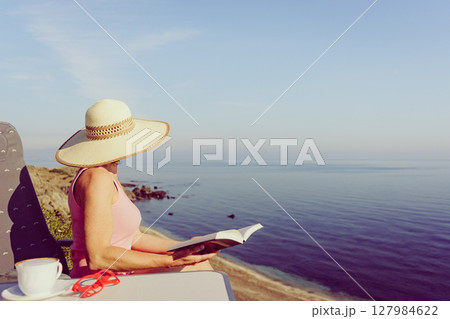 Woman on sea read book, relaxing Woman on sea read book, relaxing 127984622