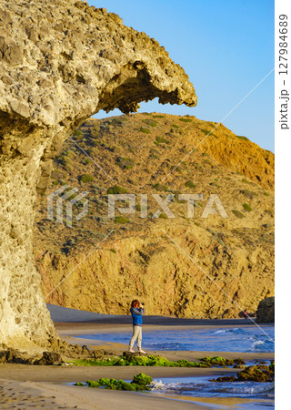 People walk on Monsul beach, Park Cabo de Gata, Spain 127984689