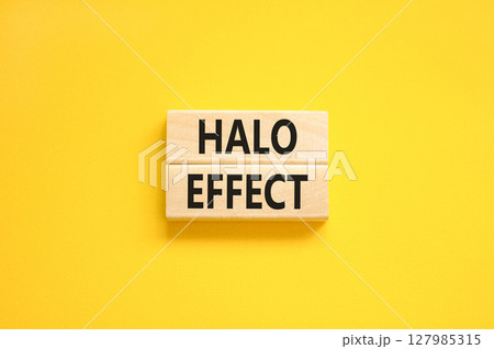 Halo effect and psychological symbol. Concept words Halo effect on beautiful wooden block. Beautiful yellow table yellow background. Business psychological and Halo effect concept. Copy space. 127985315