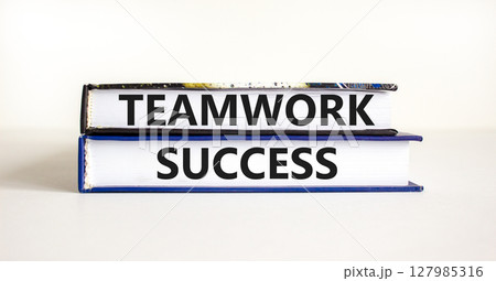 Teamwork success symbol. Concept words Teamwork success on books on a beautiful white table white background. Business and teamwork success concept. Copy space. 127985316