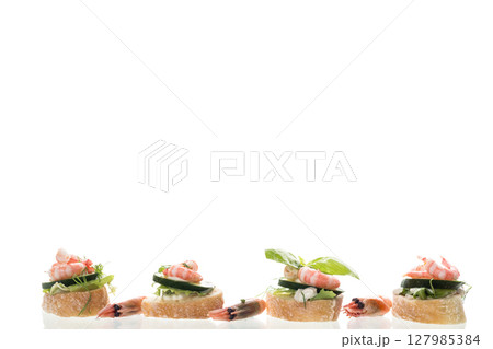 Gourmet appetizer with shrimps, greens and cucumbers for a buffet Gourmet appetizer with shrimps, greens and cucumbers for a buffet 127985384