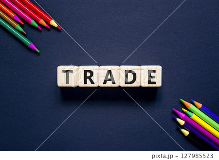 Trade symbol. Concept word Trade on beautiful wooden blocks. Beautiful black table black background. Beautiful colored pencils. Business lifestyle trade concept. Copy space. 127985523