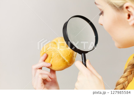 Bun bread roll and magnifying glass 127985584