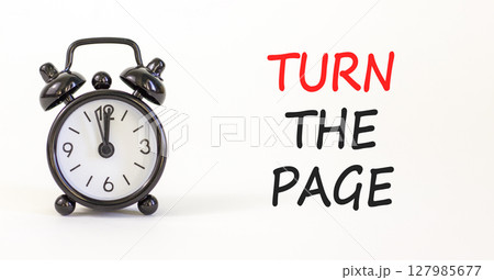 Turn the page symbol. Concept words Turn the page on beautiful white paper. Alarm clock. Beautiful white paper background. Business motivational lifestyle turn the page concept. Copy space. 127985677