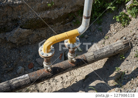 Construction site utility pipes hole 127986118