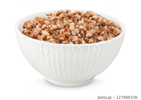Boiled buckwheat in a ceramic bowl isolated on white background 127986336