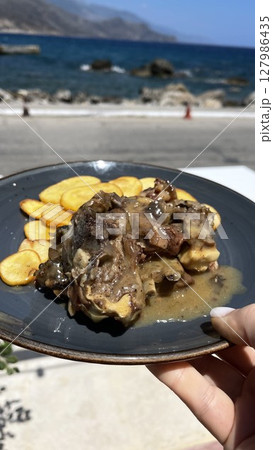 Coastal Dining with Grilled Meat and Potatoes 127986435