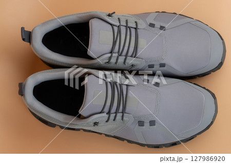 Stylish gray athletic shoes designed for comfort and performance during workouts Stylish gray athletic shoes designed for comfort and performance during workouts 127986920