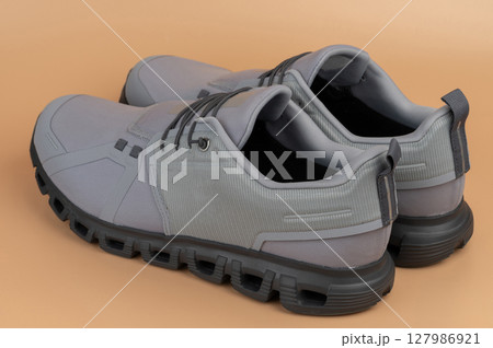 Stylish gray sneakers designed for comfort and performance during various activities Stylish gray sneakers designed for comfort and performance during various activities 127986921