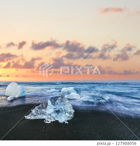 Impressive pieces of the iceberg sparkle on famous Diamond Beach at Jokulsarlon lagoon during sunset. Impressive pieces of the iceberg sparkle on famous Diamond Beach at Jokulsarlon lagoon during sunset. 127988056