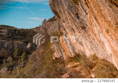 Beautiful road among the rocky yellow-red mountains Beautiful road among the rocky yellow-red mountains 127988141