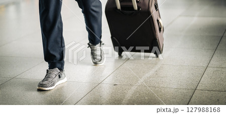 A man with a luggage at the airport checkpoint, closeup view. A man with a luggage at the airport checkpoint, closeup view. 127988168