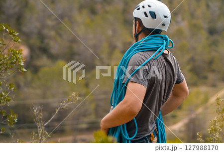 Man with a rope climbing in the mountains. Technical mountaineering. Man with a rope climbing in the mountains. Technical mountaineering. 127988170