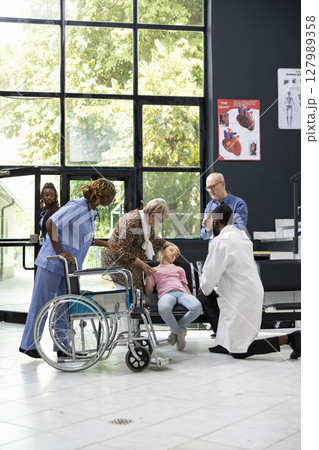 Family emergency unfolds as young niece collapses in hospital lobby, with elderly grandparents seeking diagnosis and treatment from healthcare professionals during critical pediatric situation. Family emergency unfolds as young niece collapses in hospital lobby, with elderly grandparents seeking diagnosis and treatment from healthcare professionals during critical pediatric situation. 127989358