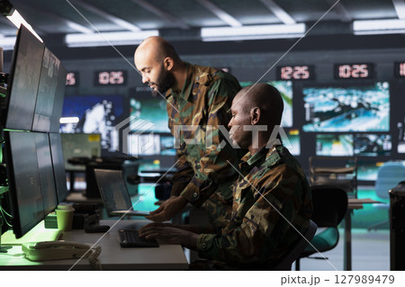 Army officers use reconnaissance technology to do threat monitoring and target recognition in command post. Military agents employing modern warfare intelligence to help soldiers defeat enemies Army officers use reconnaissance technology to do threat monitoring and target recognition in command post. Military agents employing modern warfare intelligence to help soldiers defeat enemies 127989479