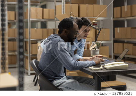 Multiethnic team of employees work in a local shipping depot, coordinating product handling and warehouse operations to help a small business grow. Distribution hub logistics. Multiethnic team of employees work in a local shipping depot, coordinating product handling and warehouse operations to help a small business grow. Distribution hub logistics. 127989523