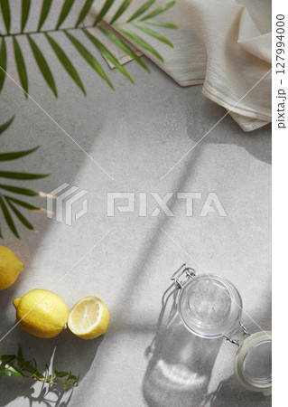 A cozy backdrop with fresh fruits and grass on a table with natural sunlight and shadows. 127994000