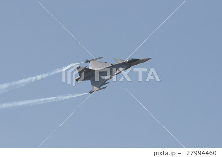 Fighter plane on blue sky background behind technology 127994460