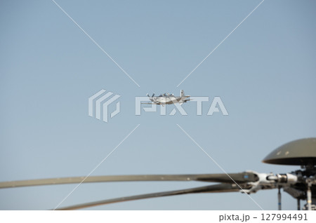 Fighter plane on blue sky background behind technology 127994491