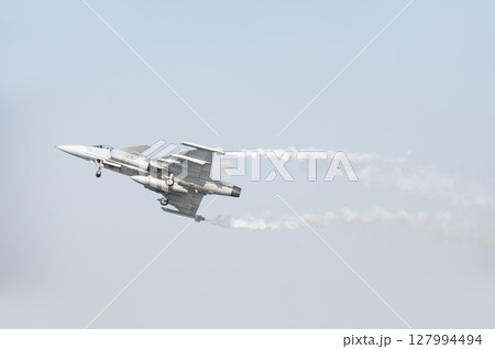 Fighter plane on blue sky background behind technology Fighter plane on blue sky background behind technology 127994494