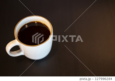 Coffee Mug On Wooden Table. Background for advertising and wallpaper in drink and coffee scene. 127996284