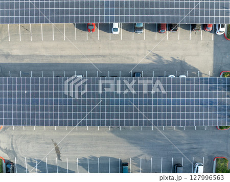 AAerial view of solar panels installed as shade roof over parking lot for parked cars AAerial view of solar panels installed as shade roof over parking lot for parked cars 127996563