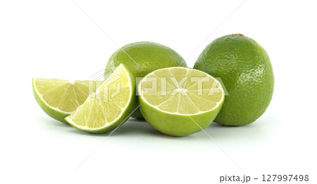 Fresh limes and slices showing the juicy pulp on white background Fresh limes and slices showing the juicy pulp on white background 127997498