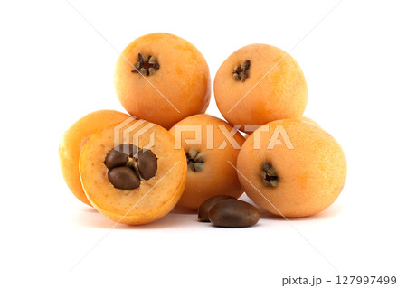 Loquat fruits, Eriobotrya japonica, showing seeds isolated on white background 127997499