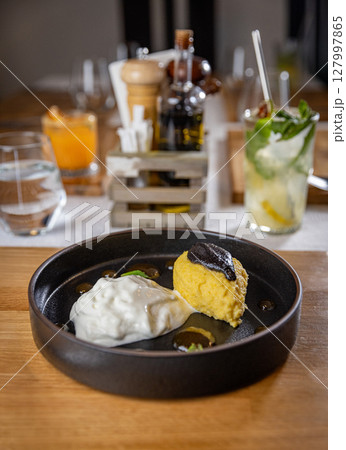 Creamy polenta with burrata cheese 127997865