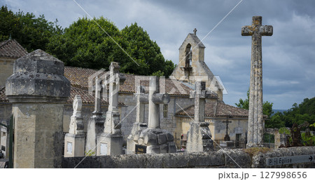 Stone cross cemetery near the church in Saint-Laurent-des-Combes highlighting religious heritage and 127998656