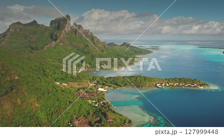 Capturing breathtaking drone footage of Bora Bora, featuring iconic mount Otemanu, luxurious overwater bungalows, and vibrant coral reefs in a tropical paradise. Travel tropical vacation concept 127999448