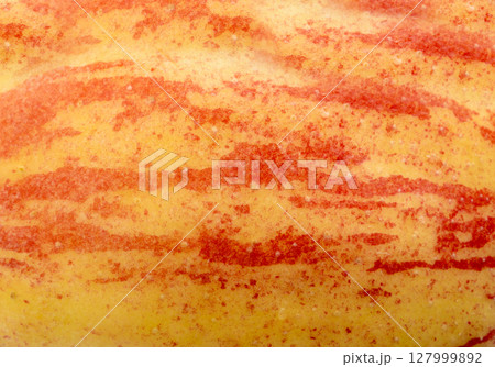 Red apple skin macro texture. Honeycrisp fruit surface close up, fresh spotted and striped apple 127999892