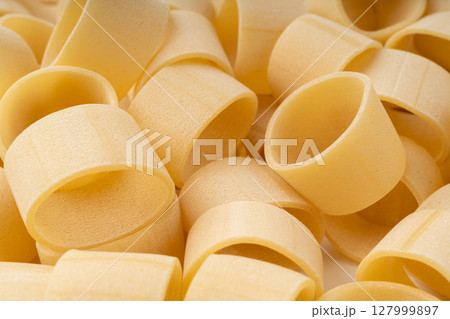 Raw Calamarata Big Pasta Isolated, Homemade Dry Macaroni, Italian Raw Round Noodle Raw Calamarata Big Pasta Isolated, Homemade Dry Macaroni, Italian Raw Round Noodle 127999897