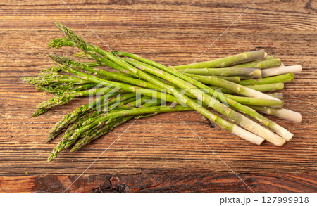 Bunch of Raw Garden Asparagus on Wood Rustic Tabletop. Fresh Green Spring Vegetables Bunch of Raw Garden Asparagus on Wood Rustic Tabletop. Fresh Green Spring Vegetables 127999918