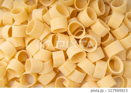 Raw Calamarata Big Pasta Isolated, Homemade Dry Macaroni, Italian Raw Round Noodle 127999923