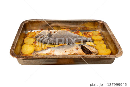 Dorado fish on a baking sheet with potatoes. Whole roasted seabream, gilt-head bream 127999946