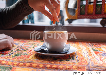Masala chai an Indian restaurant, spiced milk tea, traditional cardamom hot drink with spices Masala chai an Indian restaurant, spiced milk tea, traditional cardamom hot drink with spices 127999956