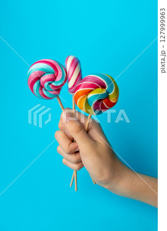 Color lollipop, spiral candy on stick, colorful striped lollypop, round fruit caramel, circle lollipop 127999963