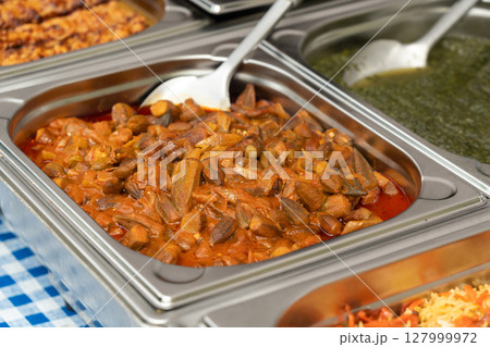 Stewed Okra, Cooked Bamya in Street Buffet, Traditional Asian Dish Bamia in Sauce Stewed Okra, Cooked Bamya in Street Buffet, Traditional Asian Dish Bamia in Sauce 127999972