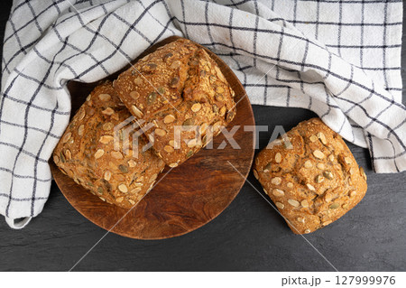 Pumpkin seeds bread, breakfast roll with pepita seeds. Fitness square bun, healthy burger Pumpkin seeds bread, breakfast roll with pepita seeds. Fitness square bun, healthy burger 127999976