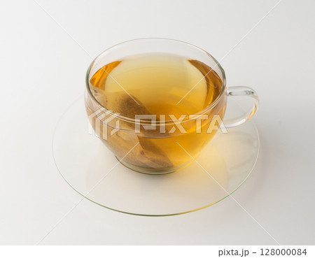 Herbal tea sachet in cup, hot water with chamomile and Hypericum or St. John's wort teabag 128000084