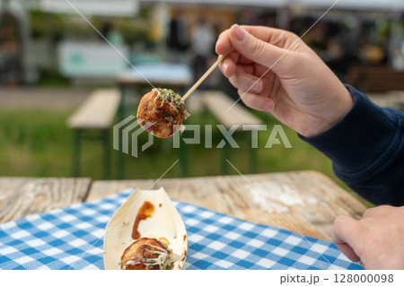 Takoyaki - traditional Japanese street food, Osaka outdoor snack with octopus, takoyaki fried balls 128000098