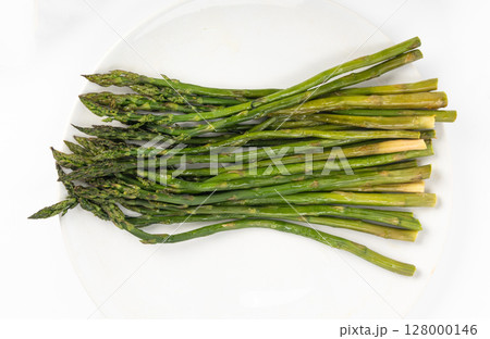 Cooked asparagus isolated. Roasted green vegetable for salad, baked asparagus bunch Cooked asparagus isolated. Roasted green vegetable for salad, baked asparagus bunch 128000146