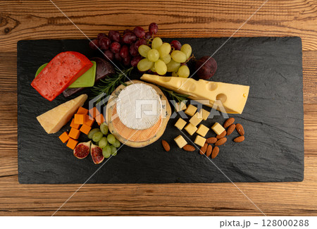 Cheese plate of color cheeses variety, yellow, white and blue cheese board, assorted dairy products Cheese plate of color cheeses variety, yellow, white and blue cheese board, assorted dairy products 128000288