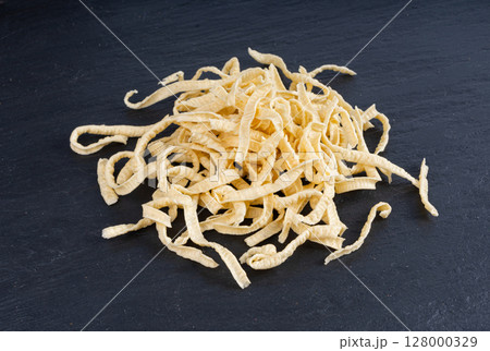 Passatelli spatzle pasta pile, raw spaetzle noodles, dry homemade german macaroni, swabian spaetzle 128000329