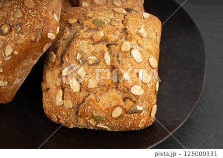 Pumpkin seeds bread, breakfast roll with pepita seeds. Fitness square bun, healthy burger Pumpkin seeds bread, breakfast roll with pepita seeds. Fitness square bun, healthy burger 128000331