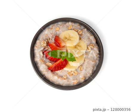 Cooked spelt in bowl isolated. Oatmeal milk porridge with fruits and berries 128000356